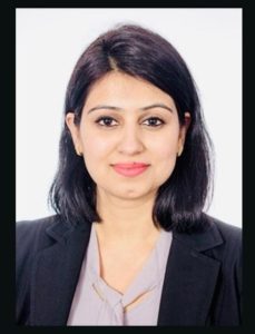 Dr Ritika Nanda Professional headshot of a woman with shoulder-length dark hair, wearing a black blazer and light blouse, looking at the camera with a subtle smile.