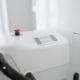 Dental emergency treatment clinic - Unique Dental of Framingham Close-up of a white medical device with a red emergency stop button and control panel.