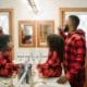 Family brushing teeth healthy habits - Unique Dental of Framingham Two men with beards in red plaid shirts brushing their teeth at a bathroom sink, facing mirrors.