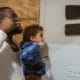 Framingham Family Dentist Makes Dental Care Easy - Unique Dental of Framingham Man holds a young child up to brush the child’s teeth in a bathroom.