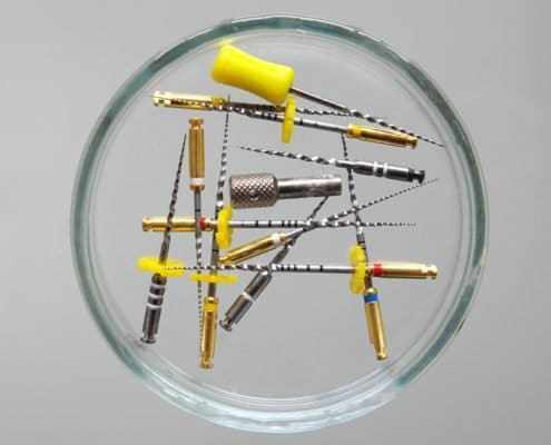 Multiple dental needles arranged in the shape of a 'O' at Unique Dental of Framingham, Massachusetts.
